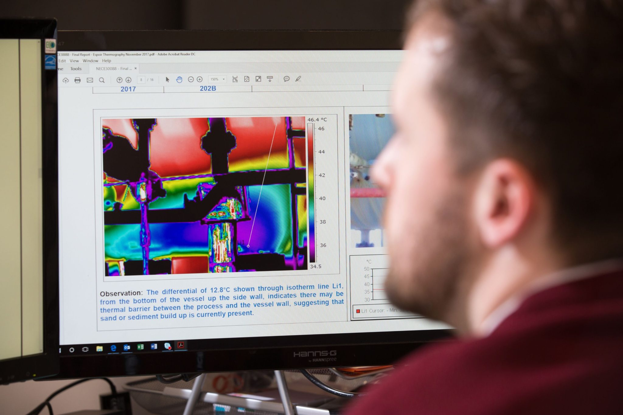 Man at computer viewing thermography report