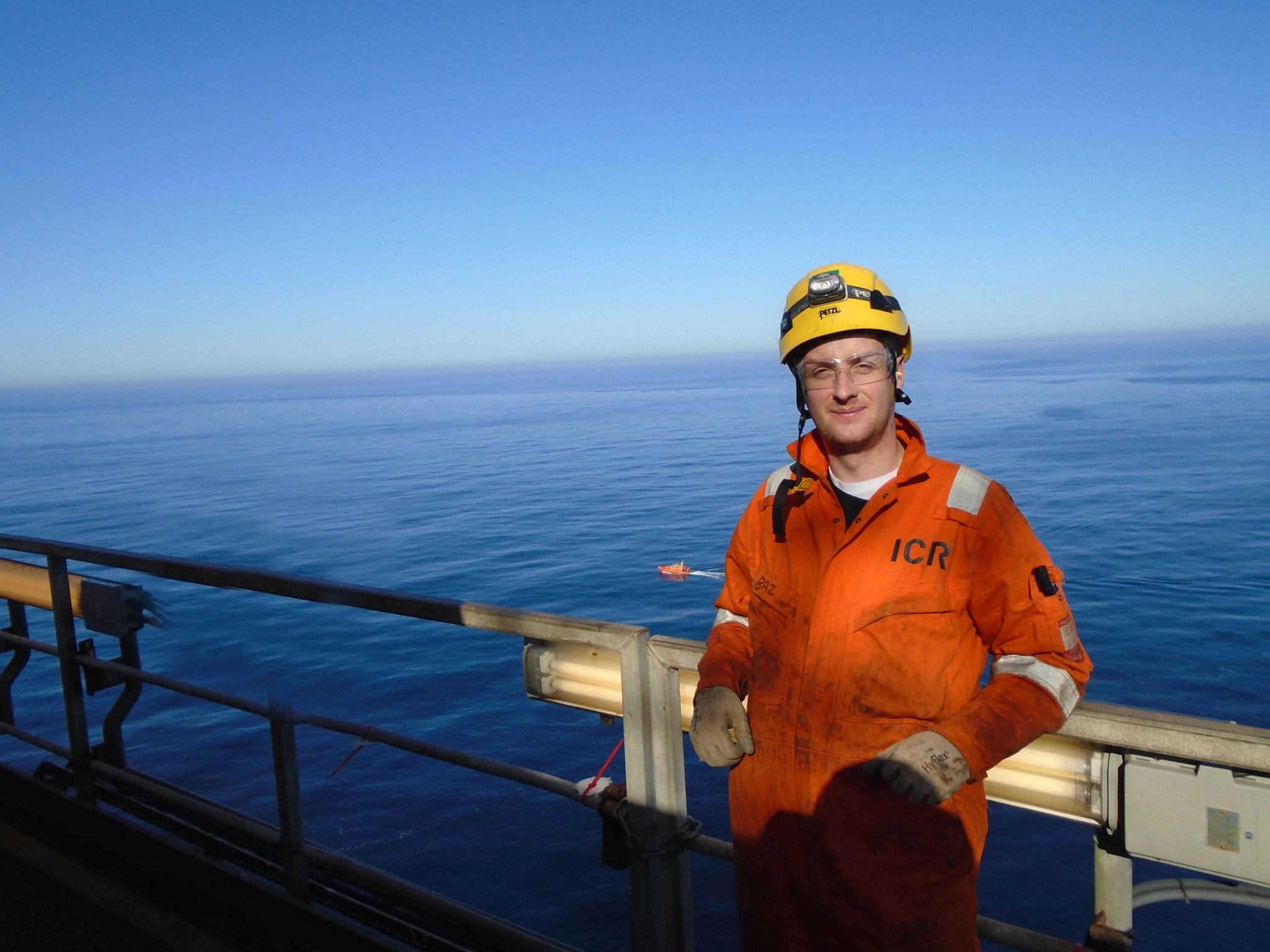 Man in overalls on asset at sea