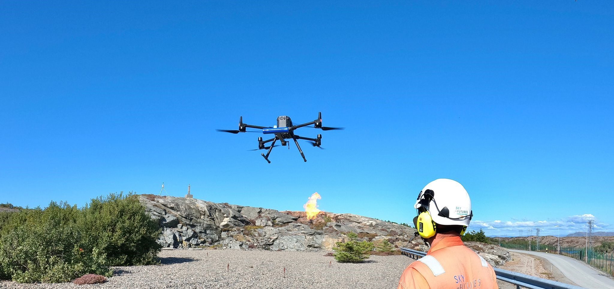 Drone with seekops sensor flying, pilot in foreground