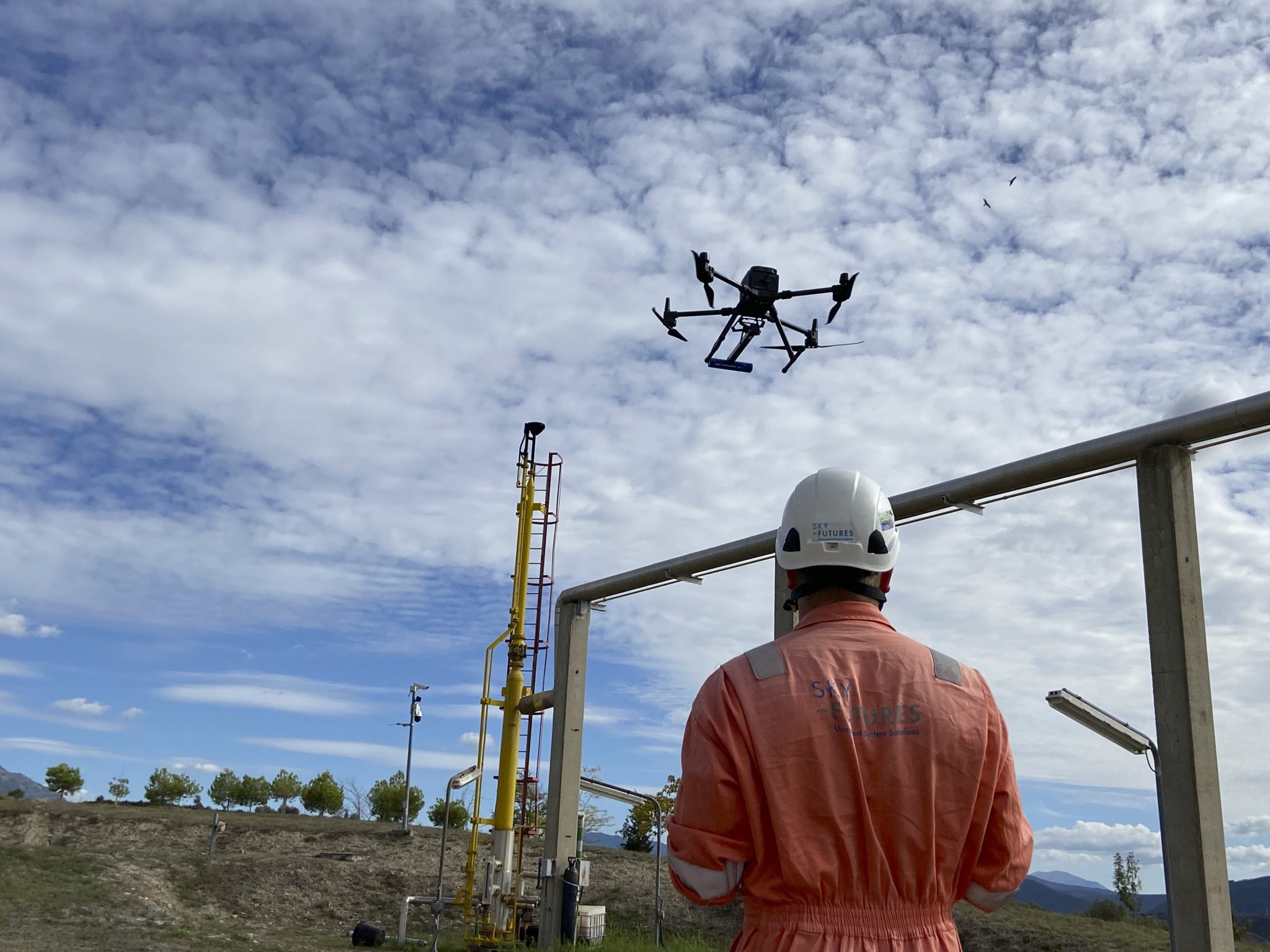 Drone pilot flying drone in sky