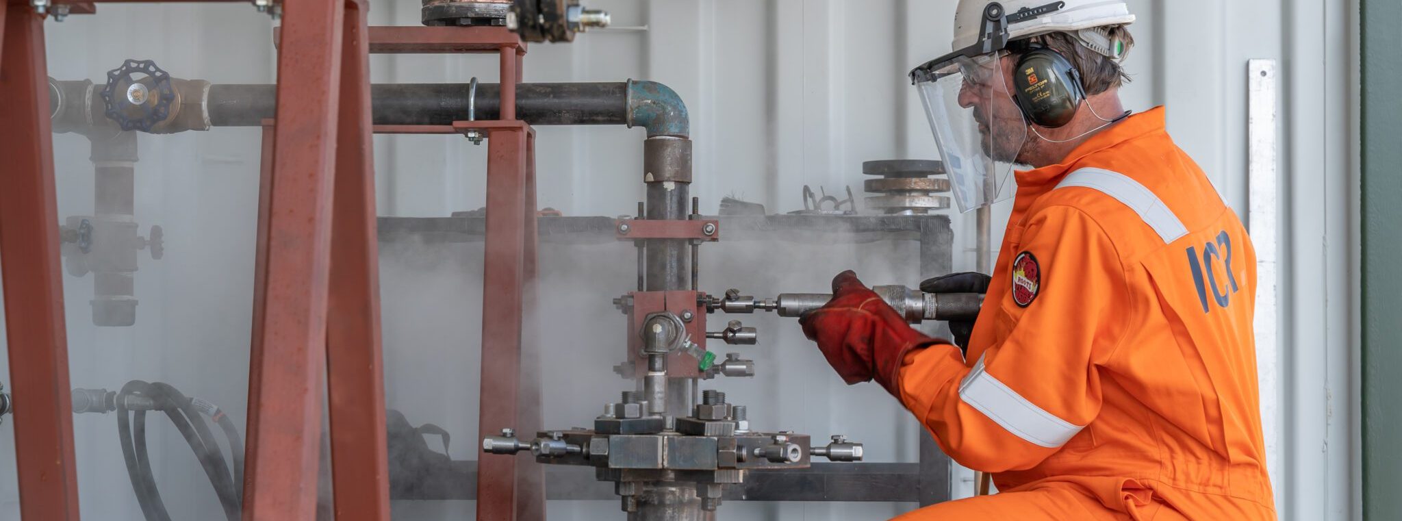 Technician injecting filler to leak sealing training rig