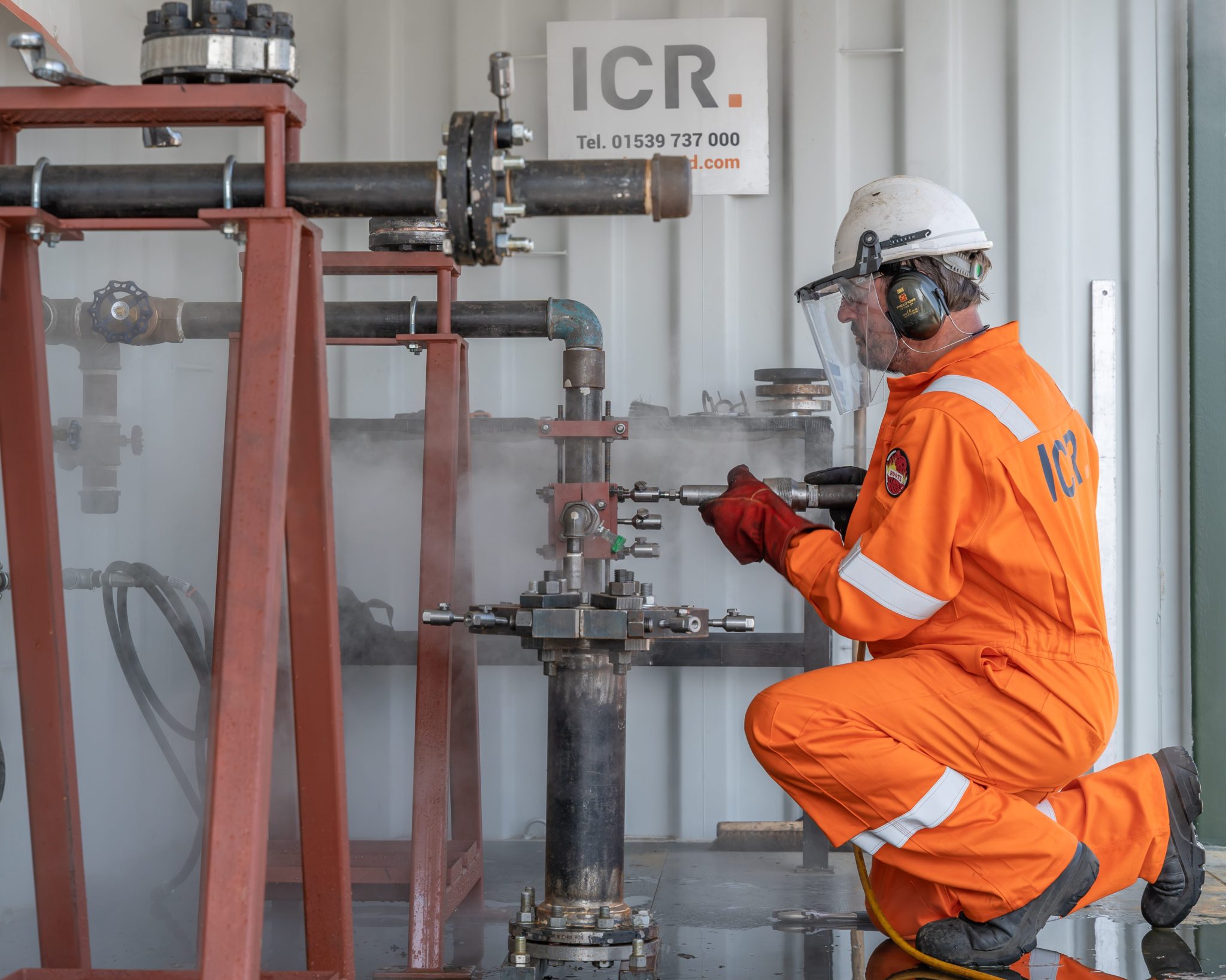 Technician injecting filler to leak sealing training rig