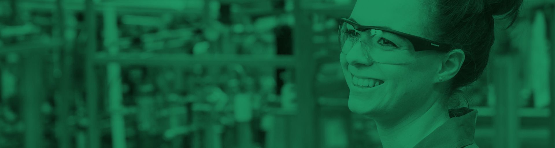 Abstract image - female technician smiling - green filter